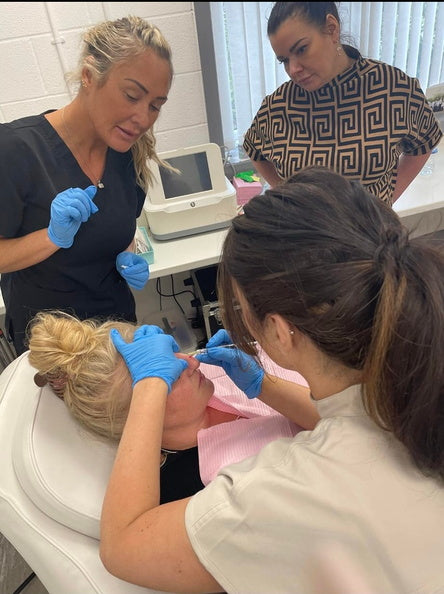 Students learning how to safely conduct aesthetic treatments