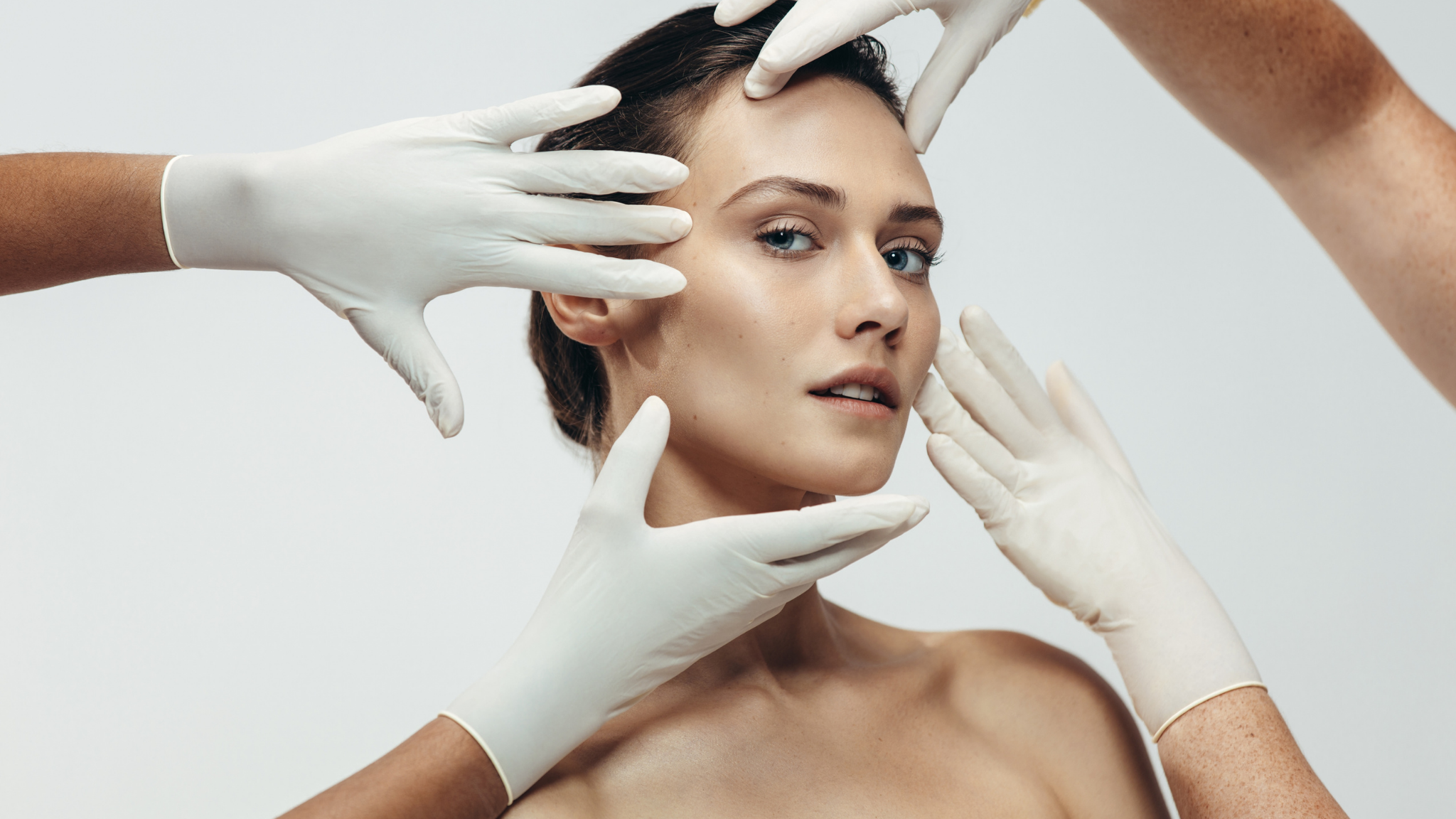 A model with a number of hands with ppe gloves on.